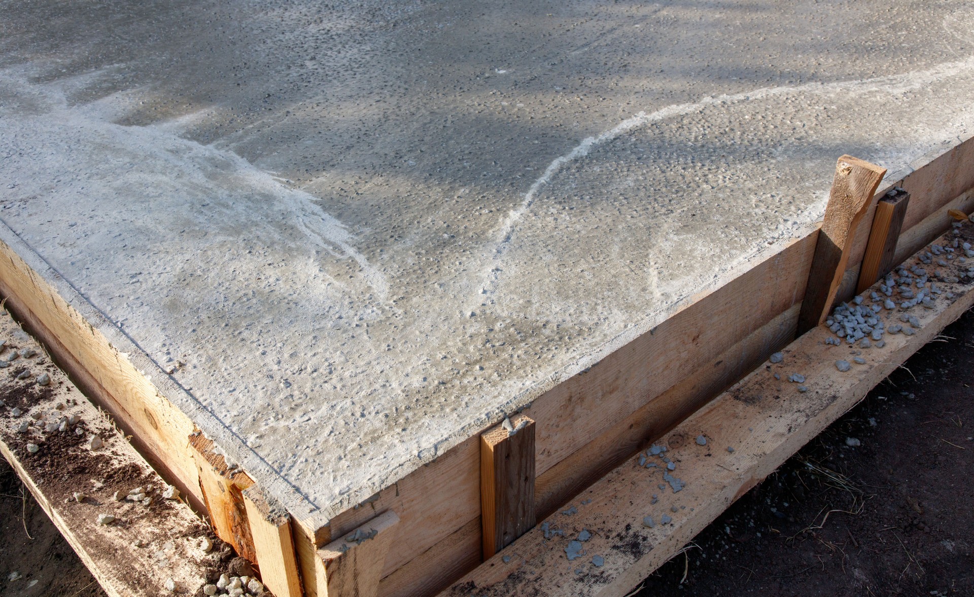 A concrete slab with a wooden frame and a white line on it